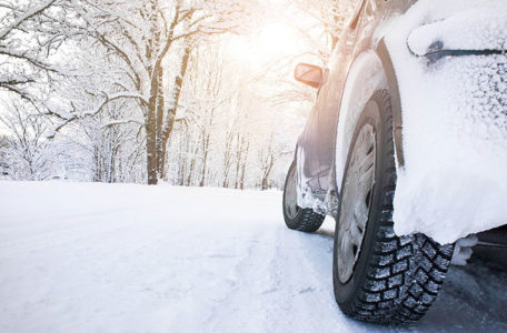 car tires on witer road in snowy morning